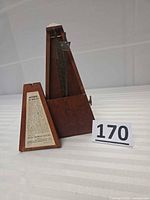 Metronome with door removed showing mechanism and label