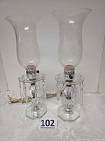 Full view of pair of crystal boudoir lamps with prisms and hurricane shades
