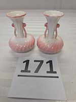 Front view of both miniature bone china vases showing swirl pattern and fluted rims