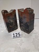 Both petrified wood bookends standing upright with lot number