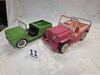 Front three-quarter view of both pressed steel vehicles