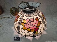 Full view of stained glass pendant shade illuminated