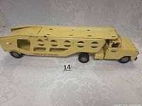 Full side view of yellow Tonka motor transport car carrier showing cab, trailer, decals, scale reference