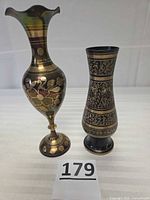 Two brass vases side by side