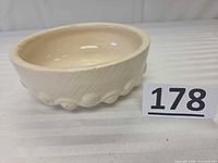 Top/side view showing shape, glaze color, ribbed base pattern