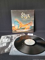 Front cover, vinyl disc on sleeve, inner sleeve edge visible