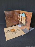 Gatefold jacket displayed with vinyl partially visible and insert in foreground