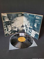 Record on inner sleeve showing yellow Reprise label and open gatefold collage