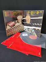 Gatefold open showing mixing console image, both records partly out of sleeves with inner sleeves visible