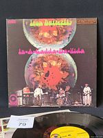 Front cover of Iron Butterfly In-A-Gadda-Da-Vida LP with vinyl foreground