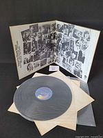 Gatefold sleeve opened showing montage artwork, both vinyl discs in inner sleeves