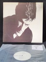 Front album cover with vinyl in poly sleeve