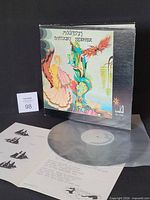 Front view of album jacket, lyric booklet and vinyl record