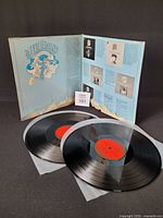 Open gatefold showing two records with red labels