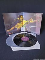 One of the two vinyl records on white inner sleeve, visible centre label