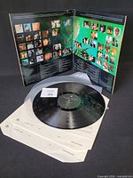 Open gatefold showing record, inner sleeves, and vinyl condition