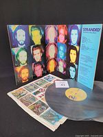 Front gatefold opened showing vinyl, inner sleeve and lot card