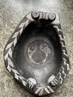 Top view showing entire bowl, fish motif and carved rim