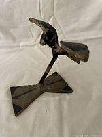 Front view of welded metal bird on base