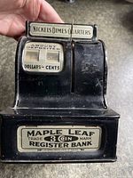 Front view showing Maple Leaf logo, register window and coin slots