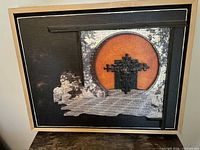 Front view of framed mixed-media relief artwork