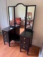 Front view showing entire vanity, trifold mirror, drawers, brass pulls