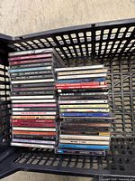 Basket containing two tall stacks of CDs