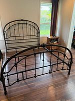 Full view of metal queen bed frame showing headboard, footboard and rails