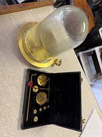 Scale set in open case beside candle holder