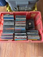 Crate with full assortment of CD jewel cases viewed from above