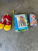 Shoes, packaged costume, packaged wig displayed on floor for full lot view