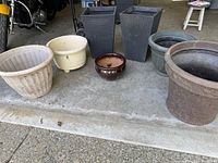 Full group of seven planters lined up on garage floor