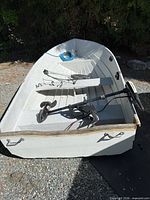 Interior view of boat showing benches, trolling motor, rod holders, rope