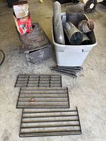 Overall lot showing stove, chimney pipes in tote, racks and boxed fan