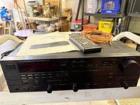 Front of Luxman R-115 with remote, manual, speaker wire