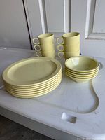 Stack of 8 plates, 6 nested cups, 5 nested bowls