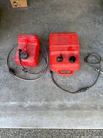 Top view showing both red plastic gas tanks with attached hoses and primer bulbs