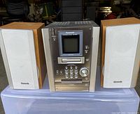 Front view of Panasonic SA-PM25 main unit flanked by two matching speakers
