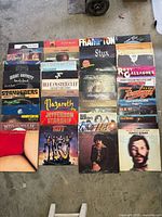 Overhead shot of 24 vinyl record sleeves laid flat