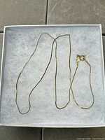 Full view of twisted rope chain necklace laid in box