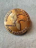 Obverse showing text, duck relief and date