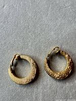 Front view of both hoop earrings showing texture and shape
