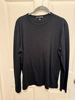 Front view of black long sleeve t-shirt on hanger