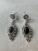 Front view of both earrings showing design and cabochons