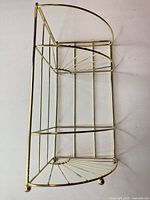 Full view of brass-plated corner shelf showing three tiers and overall structure