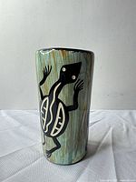Full view of cylindrical vase showing turtle motif and glaze colors