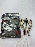 Gear puller beside storage pouch