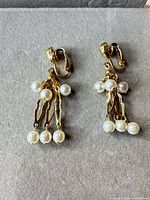 Front view of both earrings showing full design and faux pearls