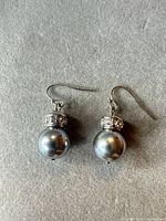Front view of both earrings showing faux pearls, rhinestone bands, hook wires