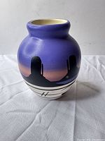 Full view of vase showing color gradient, desert motif, banded base